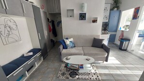 A modern living room with a sofa, a coffee table, and a patterned rug. - Air-conditioned 2-room apartment 4/5 pers with pool (Argelès-sur-Mer)