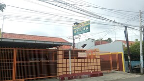 A gated property with a signboard advertising a business. - Wisma Pelita Syariah Tegal (Tegal)