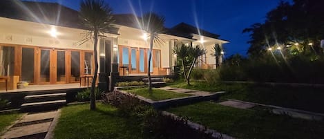 A modern house with a well-maintained lawn and a pathway leading to the entrance.