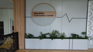 A reception area with a sign reading "Maulidia Convention Center" and a decorative wall with geometric patterns. - Maulidia Hotel Syariah & Convention Center (Jambi)