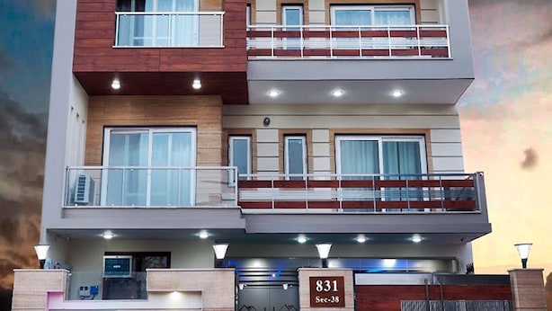 A multi-story residential building with a modern design, featuring balconies, large windows, and a garage. - The Indian Hotel & Kitchen (Gurugram)