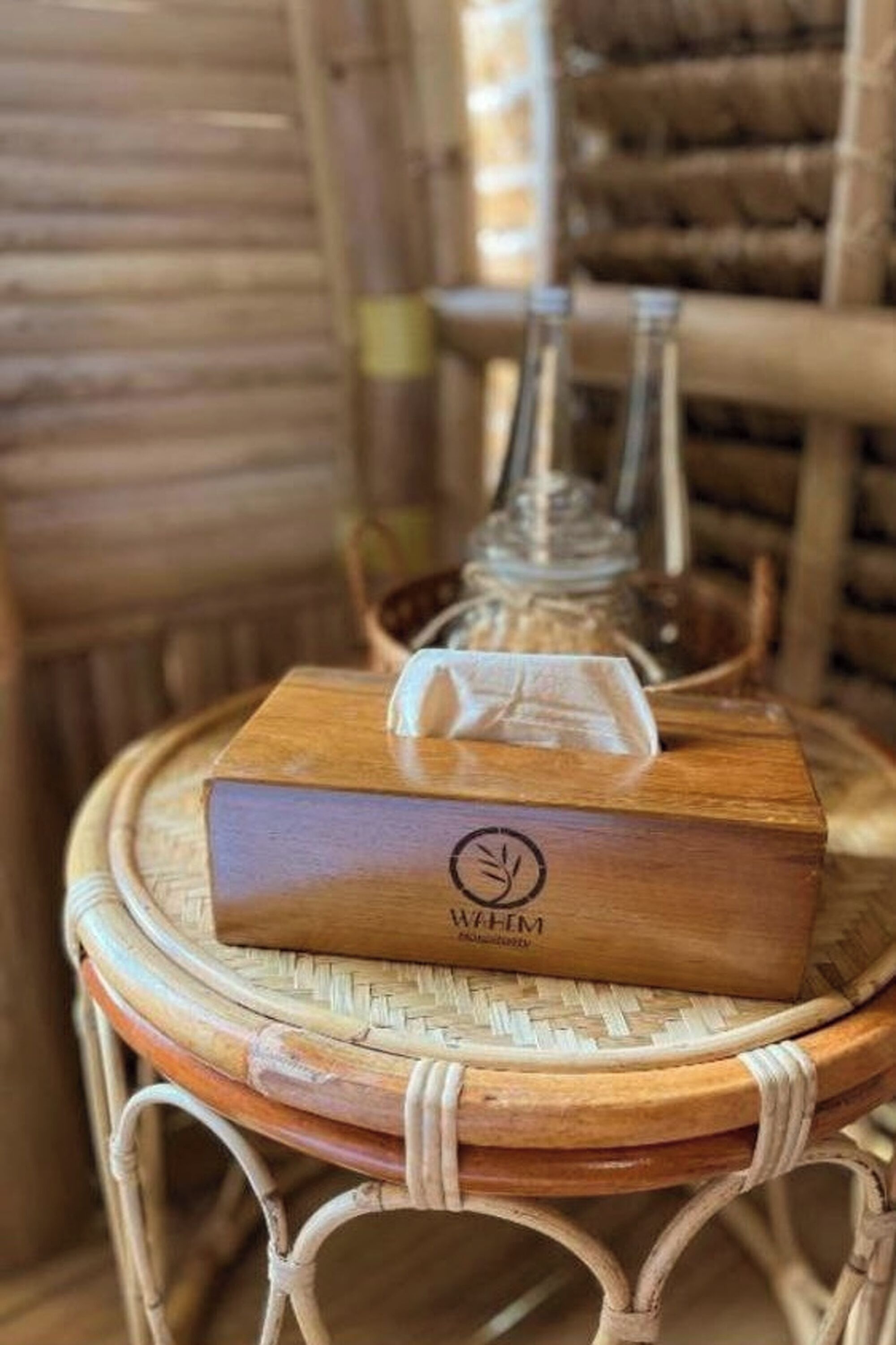 A wooden box with a logo on a wicker chair.