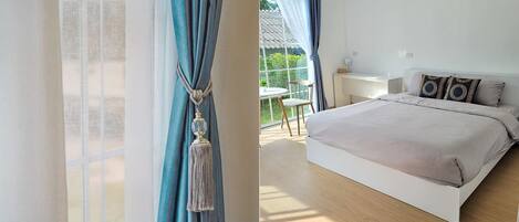 Un dormitorio con una cama grande, una ventana con cortinas y vistas al exterior.