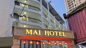 A hotel with a prominent sign reading "MAI HOTEL" and multiple balconies with railings. - Mai Hotel (Ho Chi Minh City)