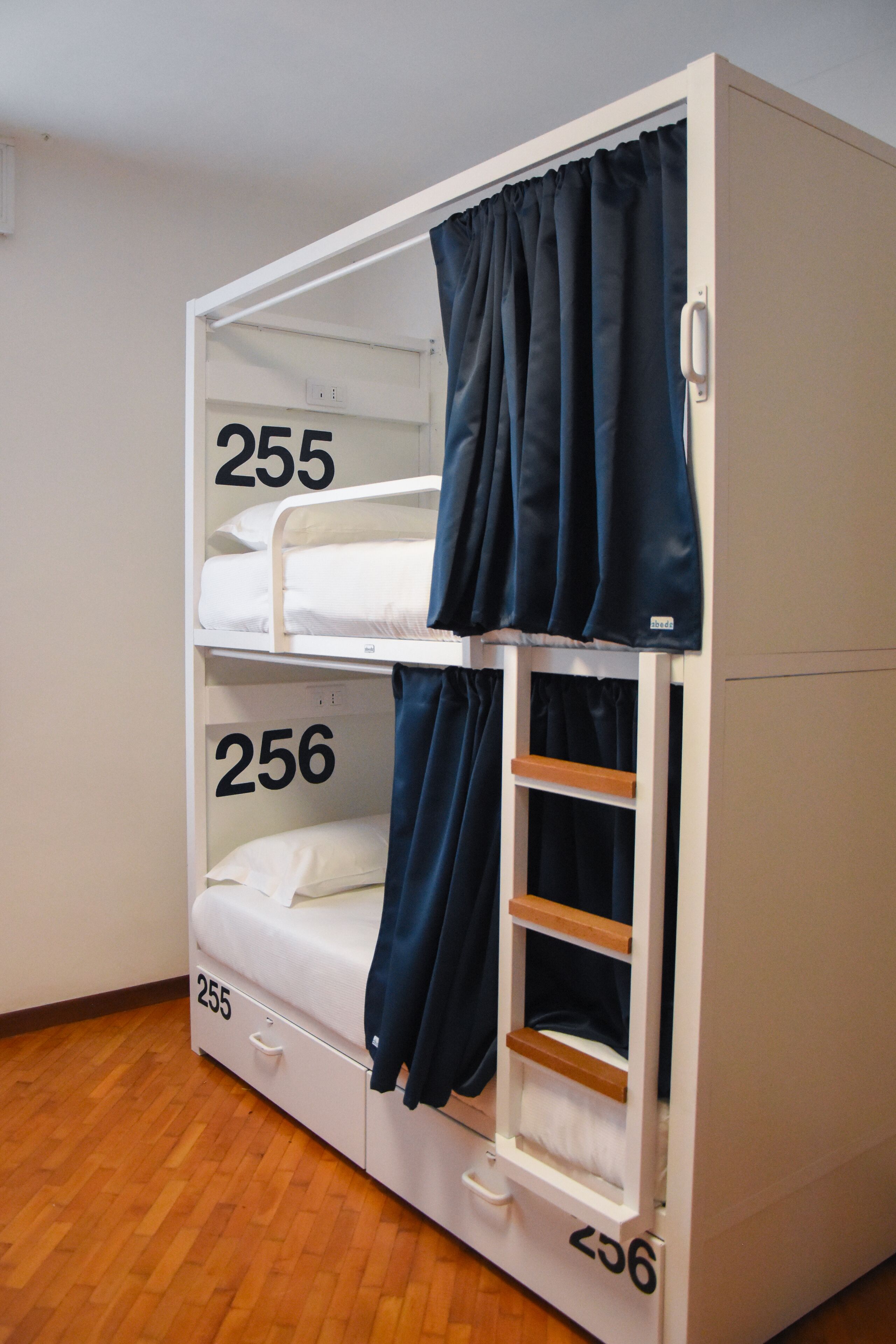 A bunk bed with three levels, each marked with a number.