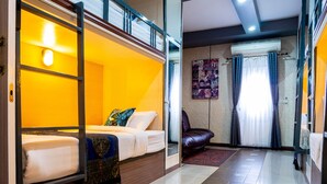 A hotel room with a bunk bed, a leather sofa, a red carpet, and a large window with curtains. - Usman Halal Home (Bangkok)