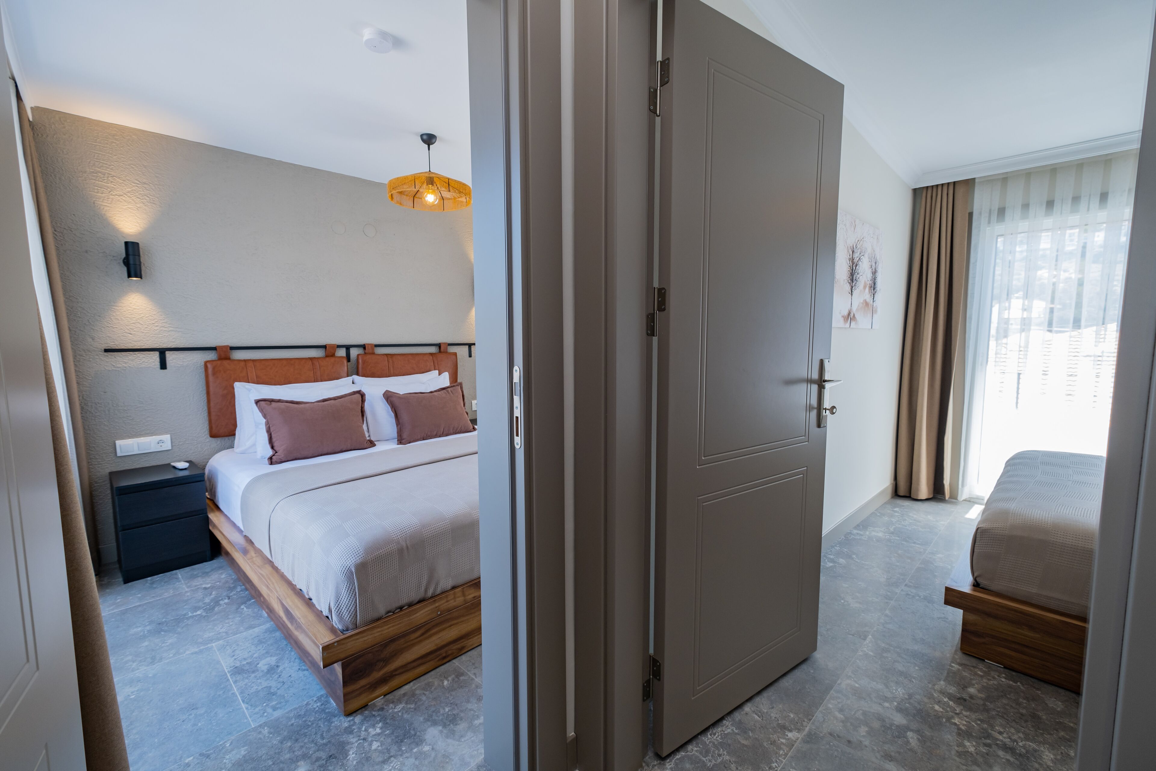 A modern bedroom with a bed, bedside table, and a nightstand.