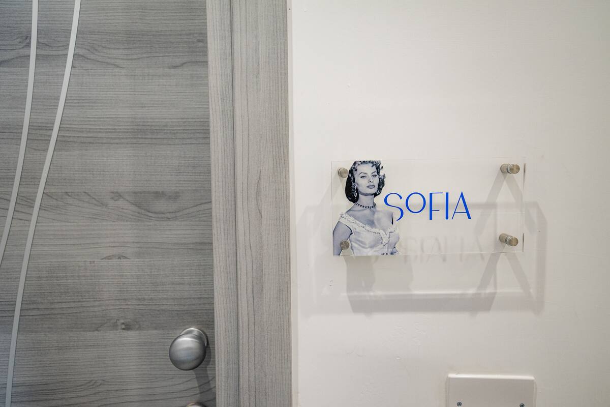A bathroom with a wooden vanity and a wall-mounted towel rack.