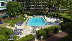 A hotel pool area with a rectangular pool, sun loungers, and a children's play area. - Hotel Decebal Neptun (Neptun)