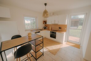 Fridge, stovetop, dishwasher, coffee/tea maker