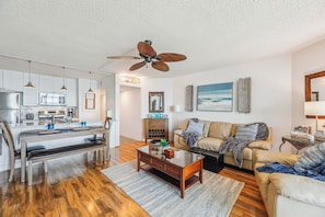 A modern kitchen with white cabinets, a dining table, and a ceiling fan. - Includes Xplorie Activities and Linens. PYRAMID - Upgraded 2BR oceanfront condo w/outdoor pool. (Ocean City)