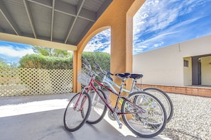 A covered outdoor area with two bicycles parked under a structure. - Modern Comfort in Vintage Green Valley 2 Bikes (Green Valley)