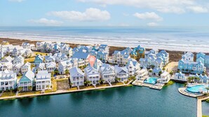 A coastal residential area with houses, a marina, and a beach. - Premier Lakefront Beach Home@Cinnamon Shore South By Luxe Pools & Amenities (Port Aransas)