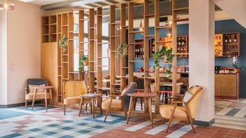 A modern interior with wooden furniture, a checkered floor, and shelves with bottles.