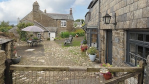 A stone cottage with a sign reading "Manger Cottage." - Manor Cottage Barn (Callington)
