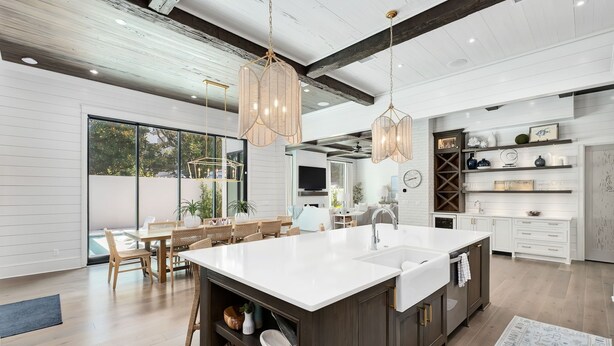 A modern kitchen with a large island, wooden flooring, and pendant lighting. - Summer Nights|Easy Beach Access|Private PoolGolf Cart (Santa Rosa Beach)