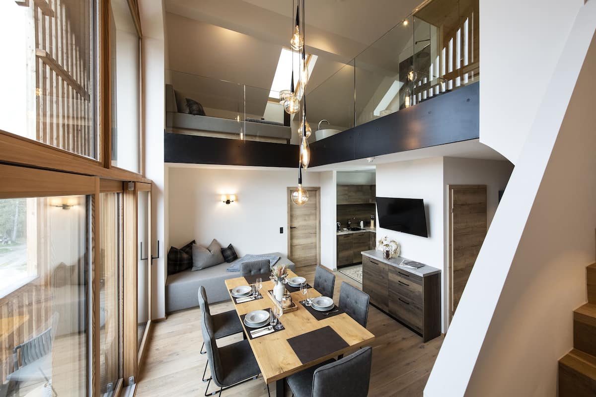 A modern interior with a dining area, kitchen, and living space.