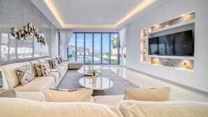 A modern living room with a sofa, coffee table, and TV.