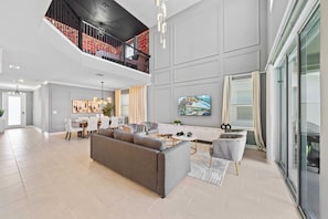 Magnificent Living Area of the Home in Davenport Florida - Unwind in style in thoughtfully curated living area - Featuring a harmonious blend of upscale decor and inviting ambiance - Smart TV and Netflix - High Ceilings - 5BR Home w/ Game & Themed Rooms at Champions Gate (Kissimmee)