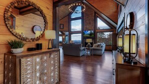 A spacious living area with a wooden ceiling, large windows, and a fireplace. - Wine Down Ridge- Blue Ridge GA (Blue Ridge)