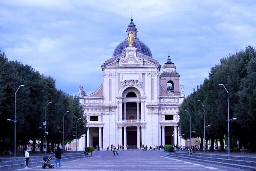A large, historic building with a prominent dome and a bell tower.