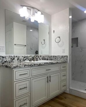 Shower, hair dryer, towels, toilet paper