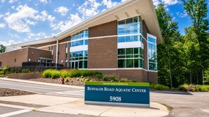 A modern building with a sign reading 'Buffalo Road Aquatic Center 5908.'