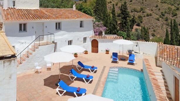 A villa with a swimming pool, outdoor seating, and a view of the surrounding hills. - The Little Well: Private Pool, Sleeps2, Views (Frigiliana)