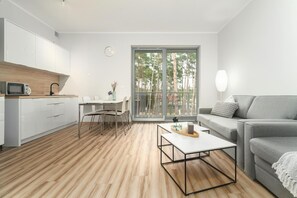 A modern living space with a kitchen, dining area, and seating area. - Holiday studio very close to the seaside beach (Pobierowo)