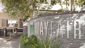 A building entrance with a sign reading "MAYYEARF".