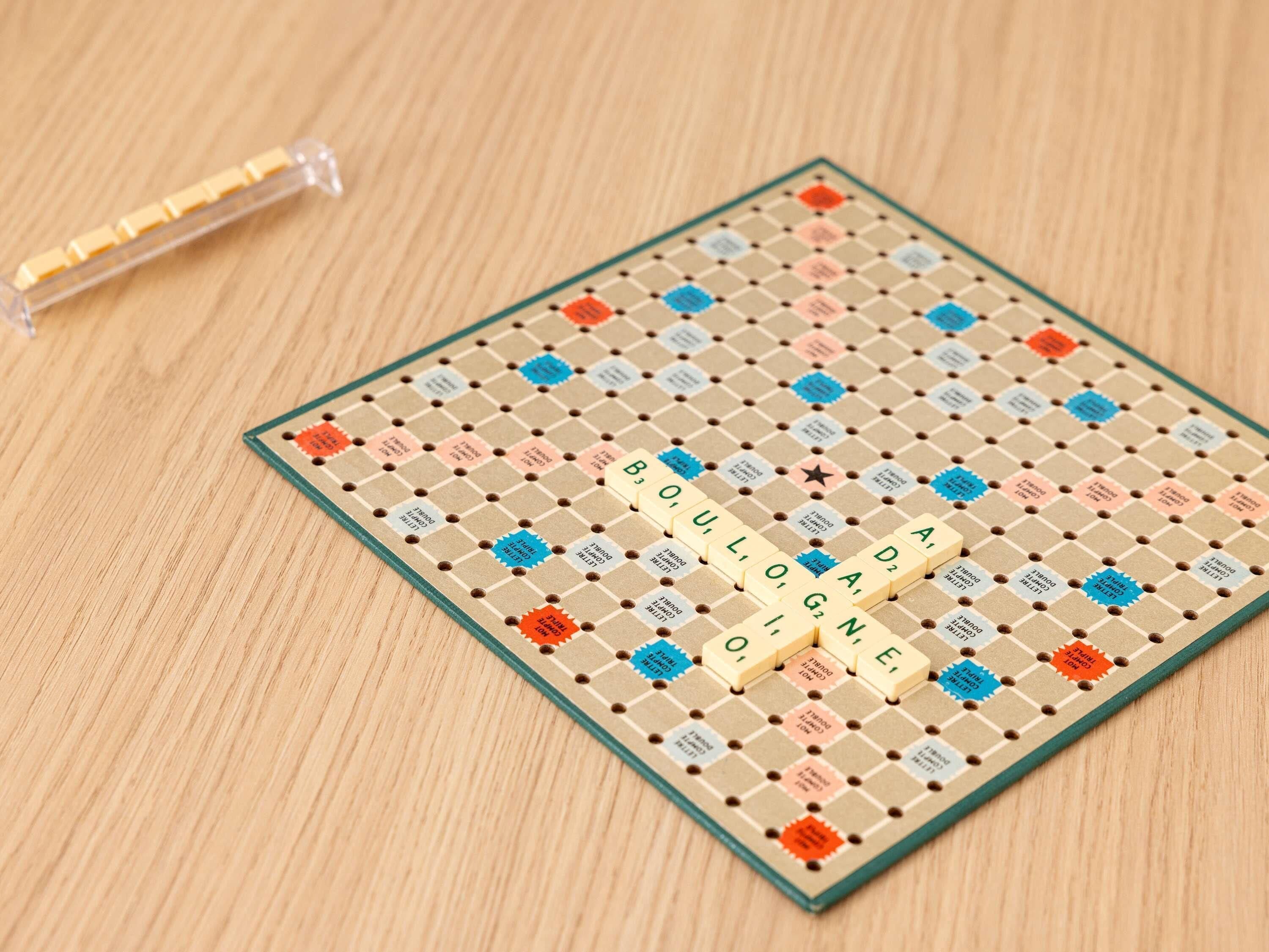 A Scrabble game board with tiles and a bag of tiles.