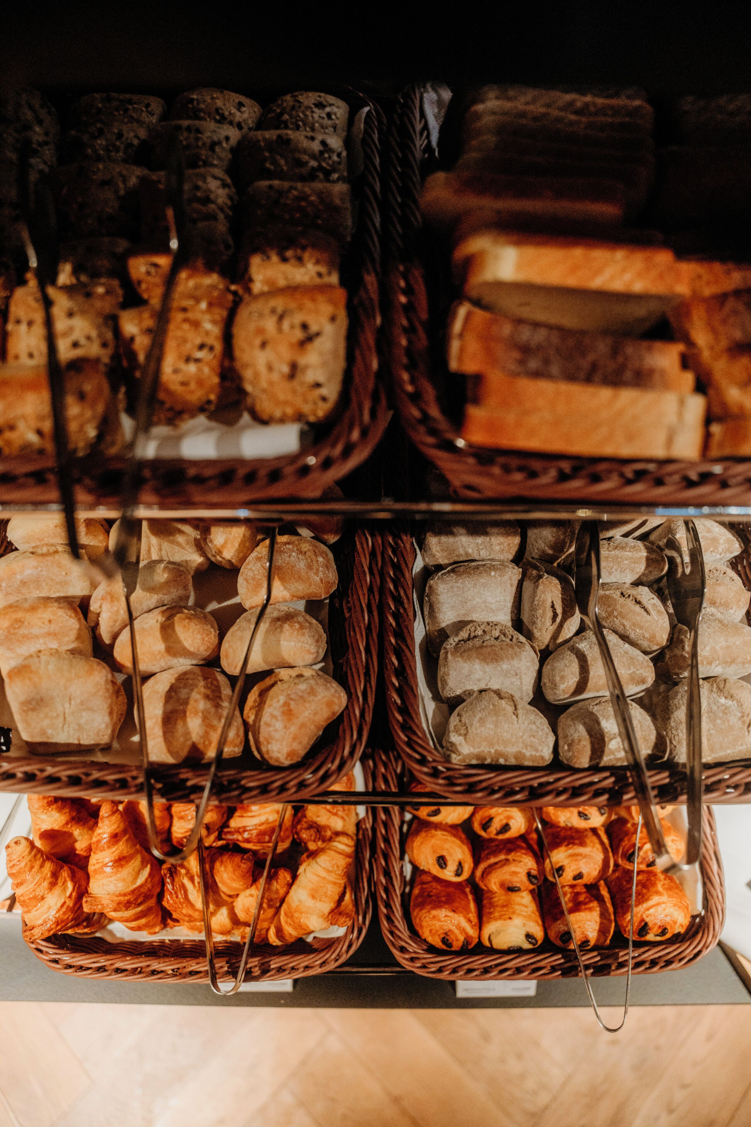 A display of various baked goods in baskets.