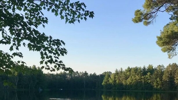 A serene lakeside setting with a dock and a red chair. - Nordic Hideaway on Silverthorn Lake - Little Sisu (Hayward)