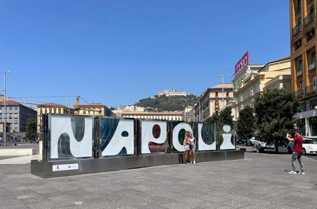 A large outdoor sign with the word "NAPOLI" in bold letters, indicating a location or landmark.