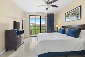 Relax in this serene retreat with a large bed, ceiling fan, and stunning balcony views.