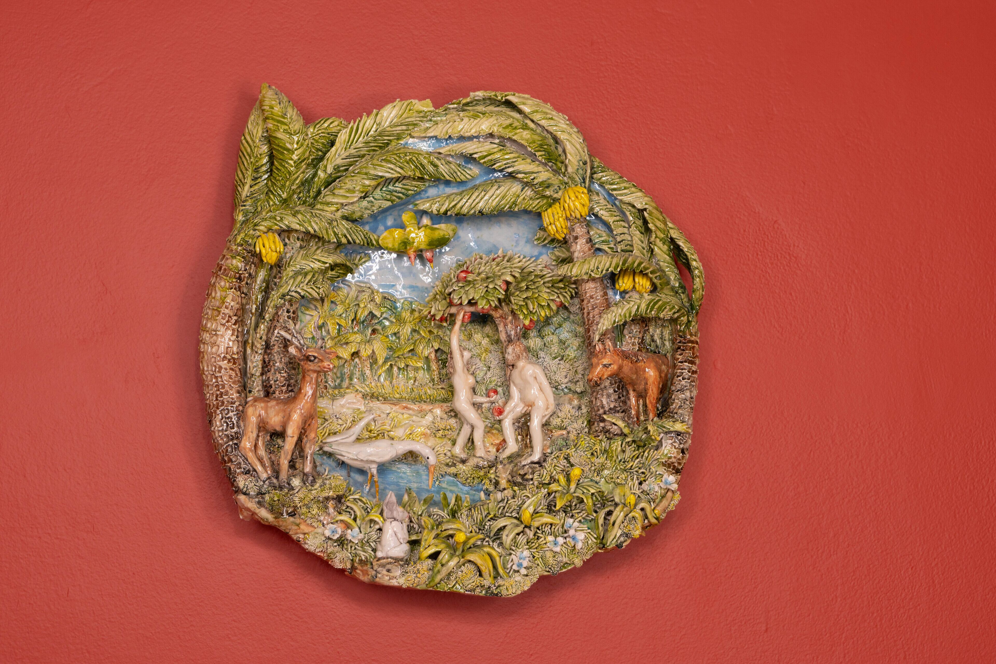 A decorative wall piece with a nature scene, including animals and foliage.