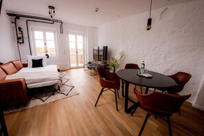 Relax in this inviting living space with a comfortable sofa, dining area, and flat-screen TV.