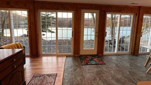 A spacious room with large sliding glass doors leading to a patio area. - Lakefront Connecticut Oasis - Updates throughout  (Oxford)