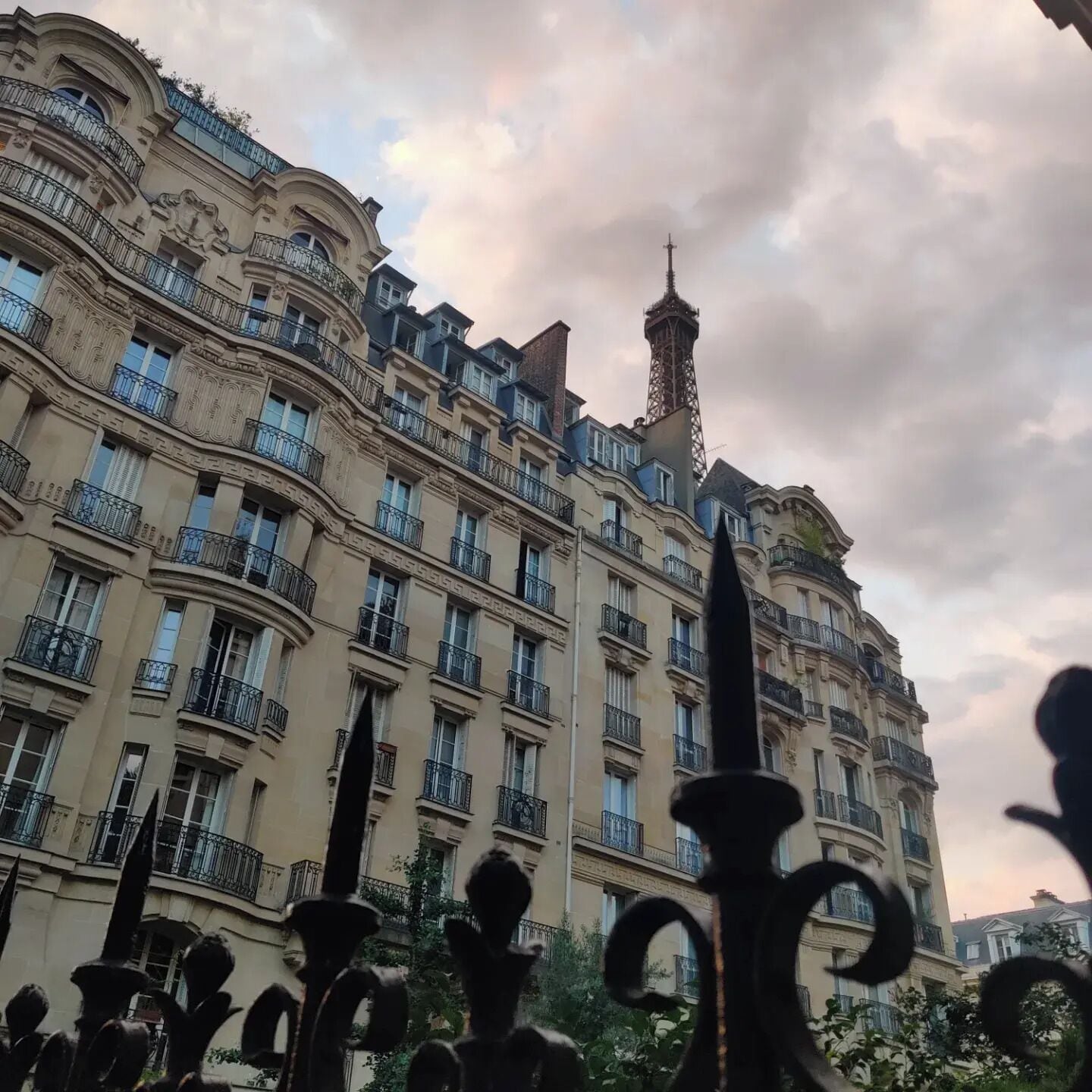 A multi-story building with ornate balconies and a tower.