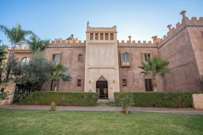 A large building with a central entrance, multiple windows, and a symmetrical facade.