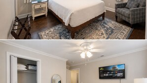 Une chambre à coucher avec un lit, un ventilateur de plafond, une télévision, une armoire et un tapis à motifs.