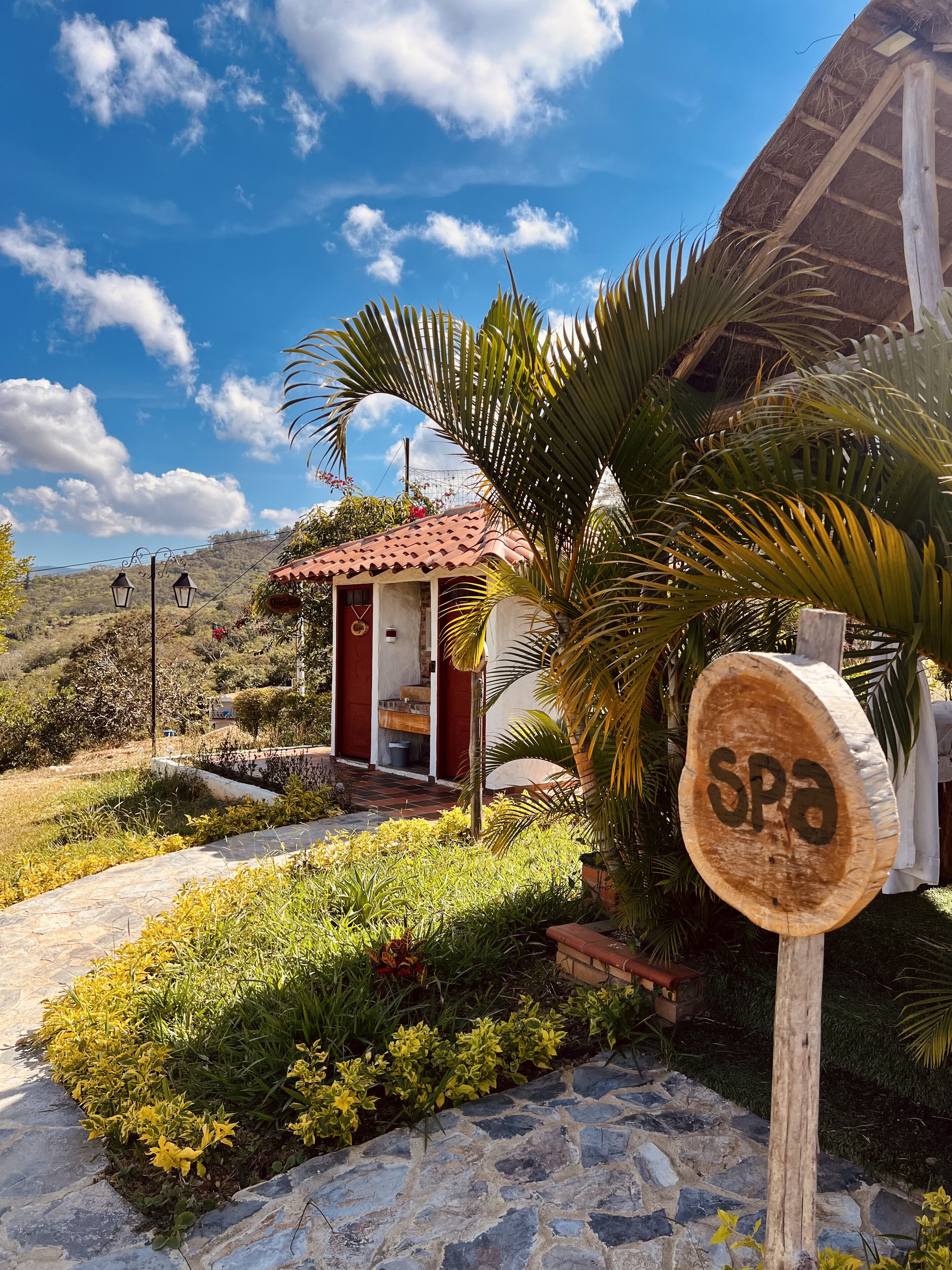 A small building with a red roof and a sign indicating a spa.
