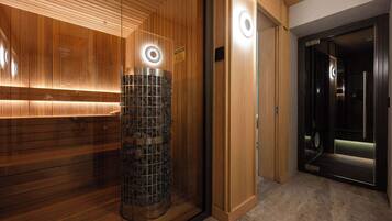 A modern elevator with a circular light fixture and a wooden panel wall.