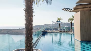 Indoor pool, outdoor pool, pool umbrellas, pool loungers