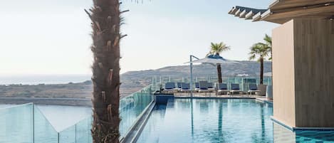 Indoor pool, outdoor pool, pool umbrellas, sun loungers