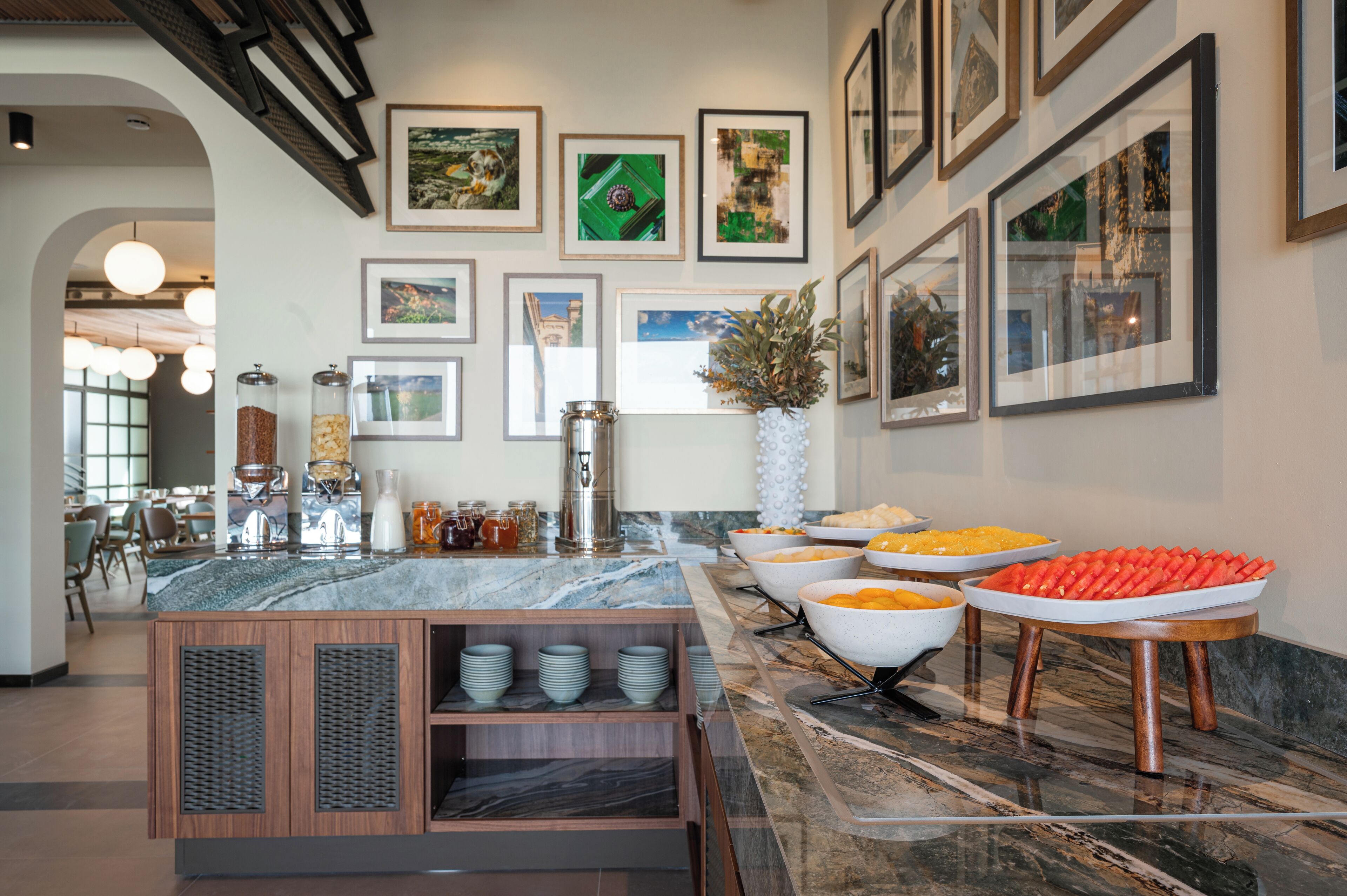 A buffet area with various food items and a marble countertop.