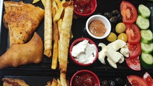 A tray of food including fish and chips, fries, and various dips. -  Avio Hotel (Diyarbakir)