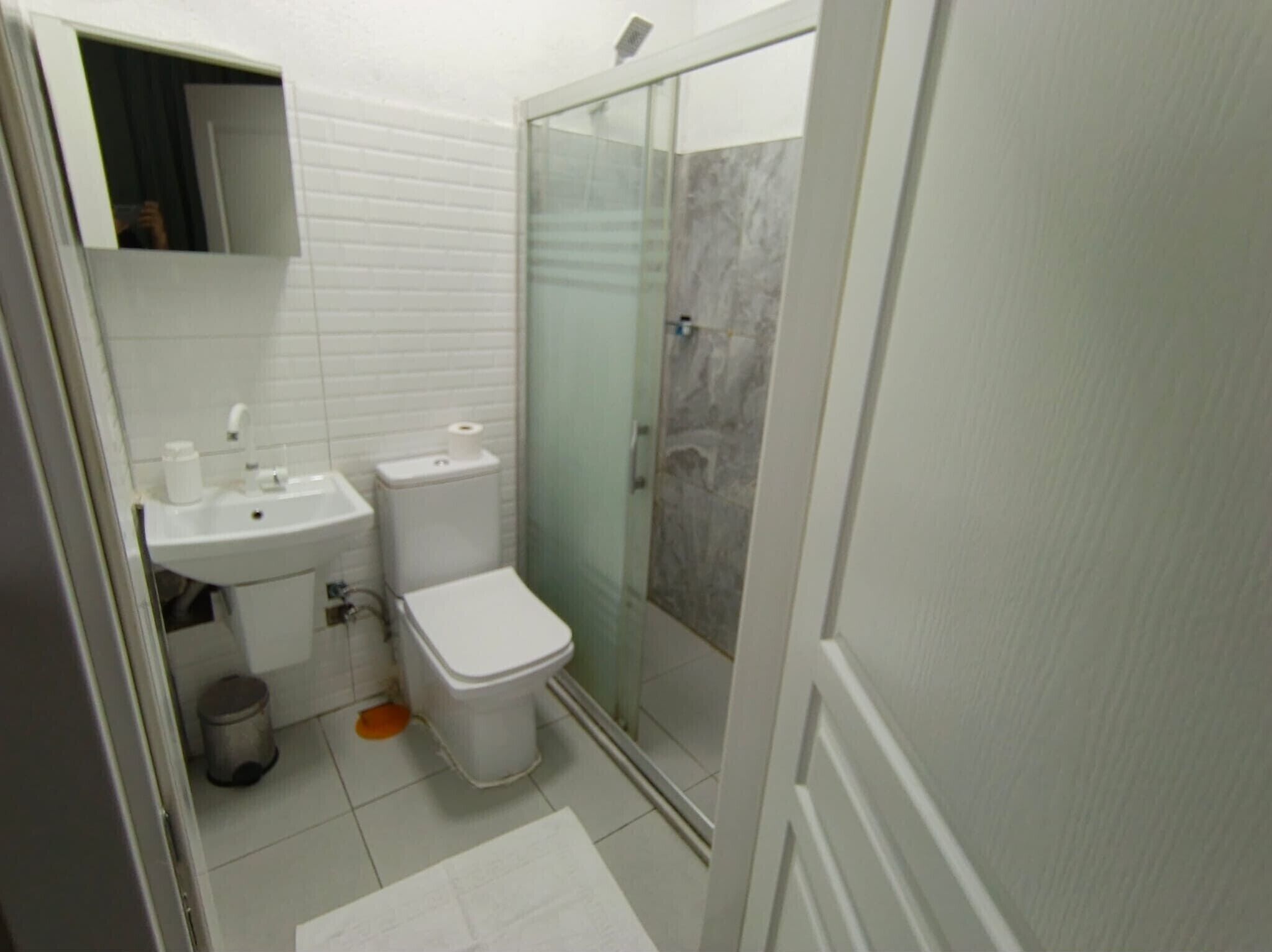 Shower, hair dryer, slippers, towels