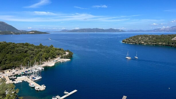 A marina with boats docked, surrounded by water and greenery. - Kristi - Three Bedroom Villa, Sleeps 6 (Spartochori)