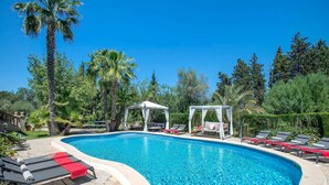 A swimming pool with lounge chairs and a gazebo. - C'an Pontarro - Five Bedroom Villa, Sleeps 10 (Mallorca)